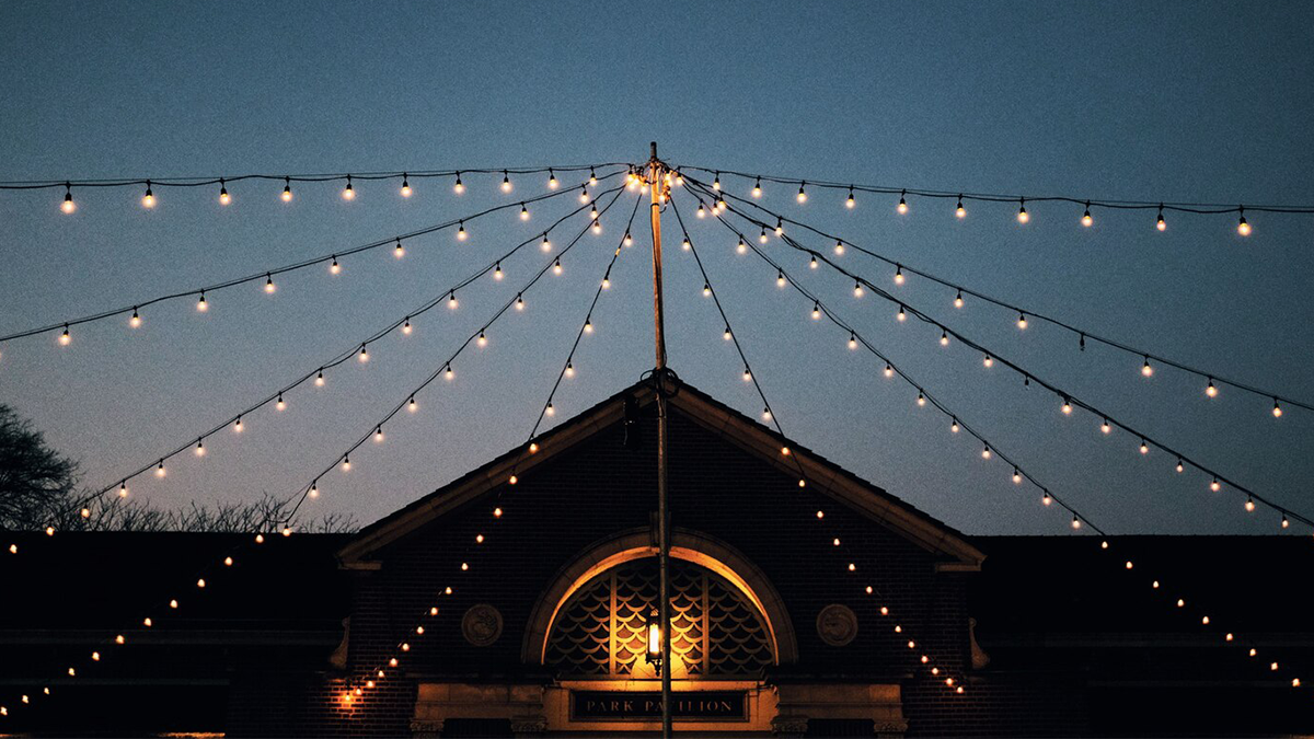 A festive neighborhood street party with decorations and tables set up outdoors