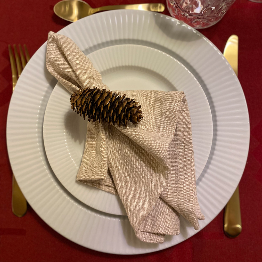 Napkin twisted at the top and decorated with a ribbon