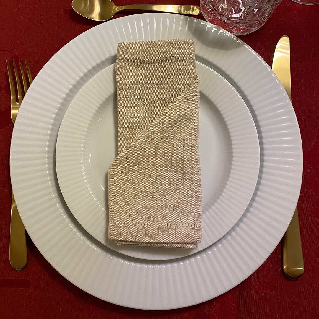 Napkin folded into a pocket shape to hold cutlery or a small decoration