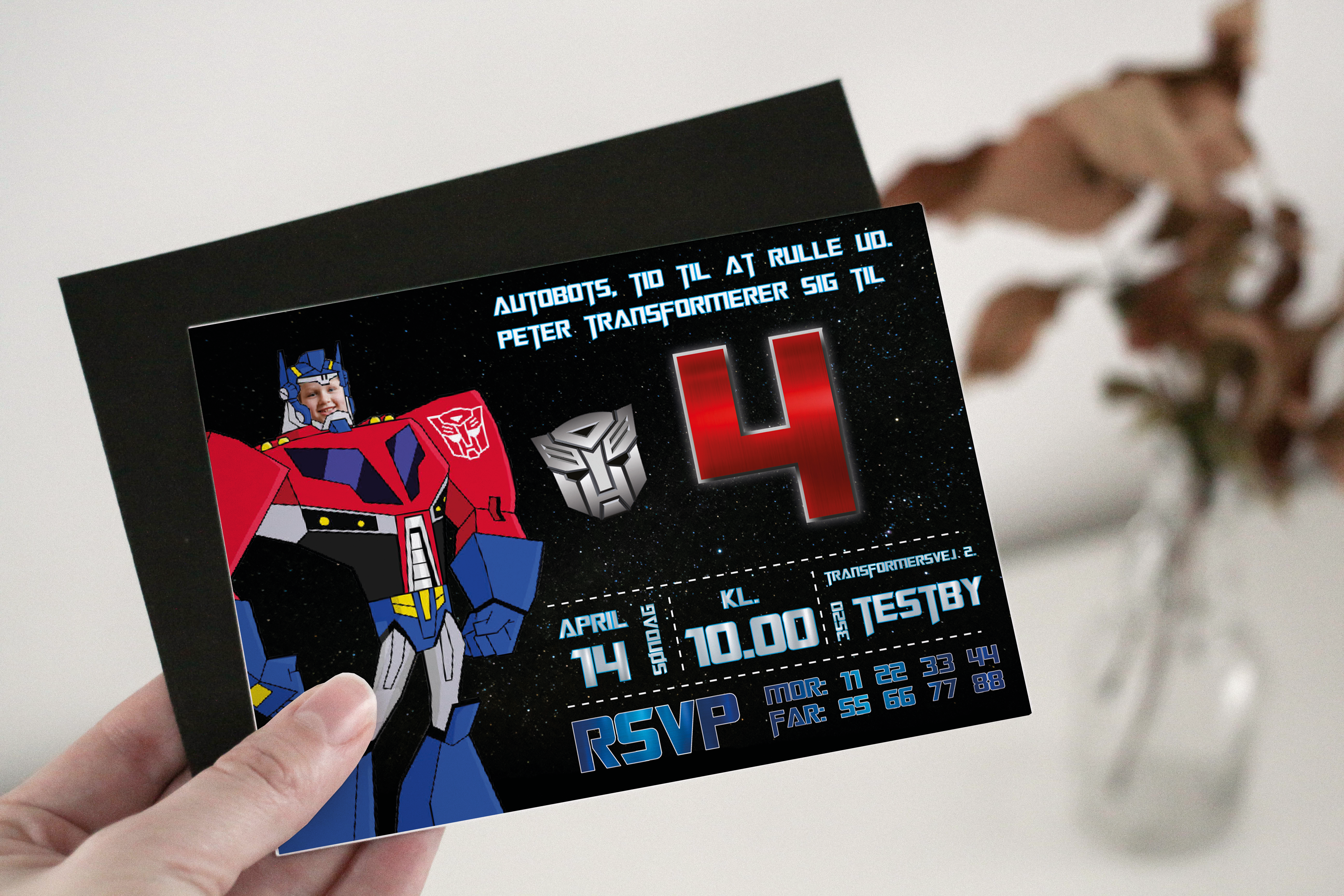 Transformers-themed party invitation held in hand