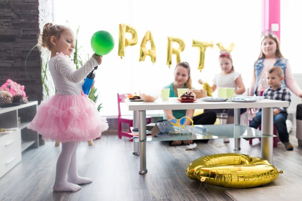 Little girl inflating a balloon for a potty-training celebration party