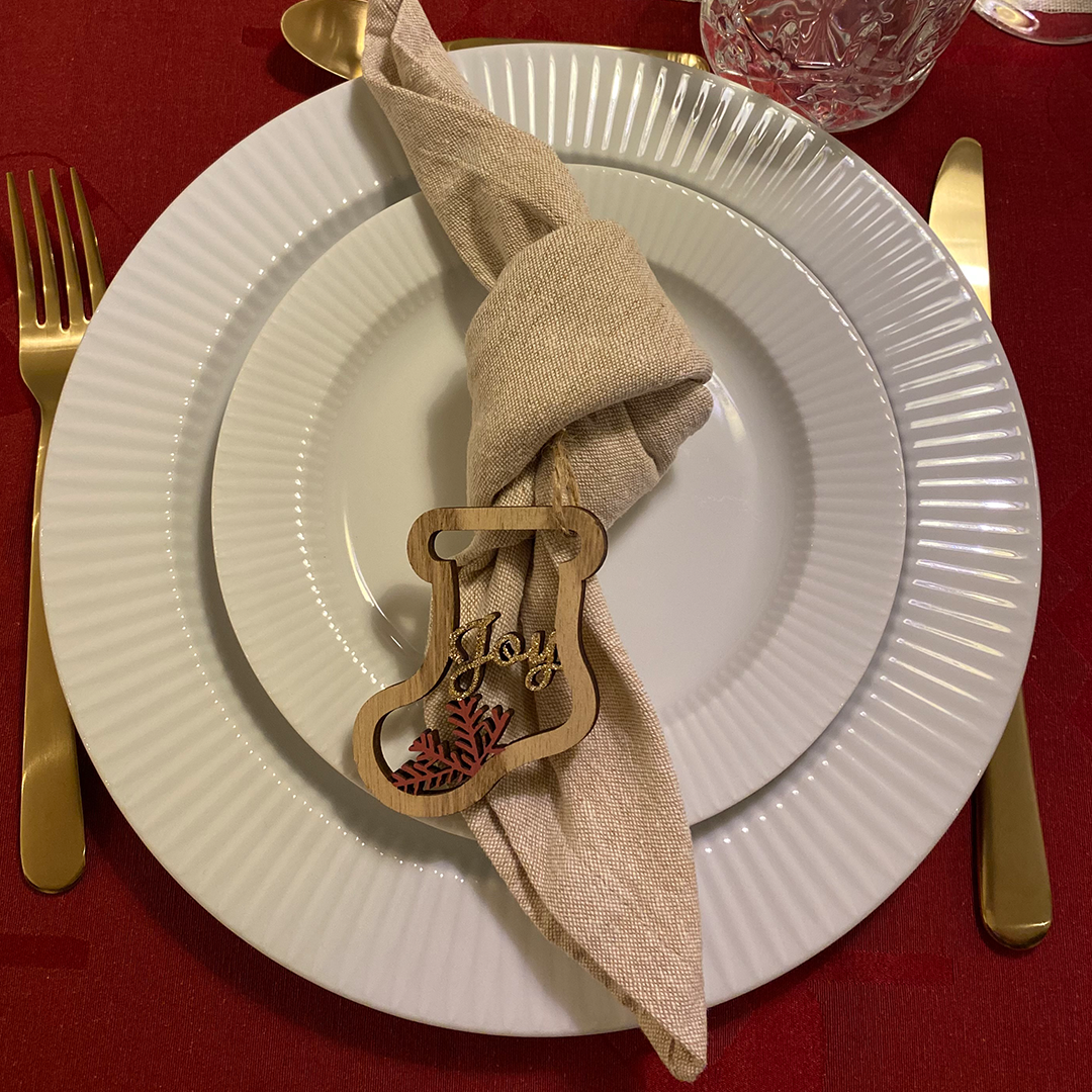 Napkin folded into the nut-tie style with a decorative tie in the middle