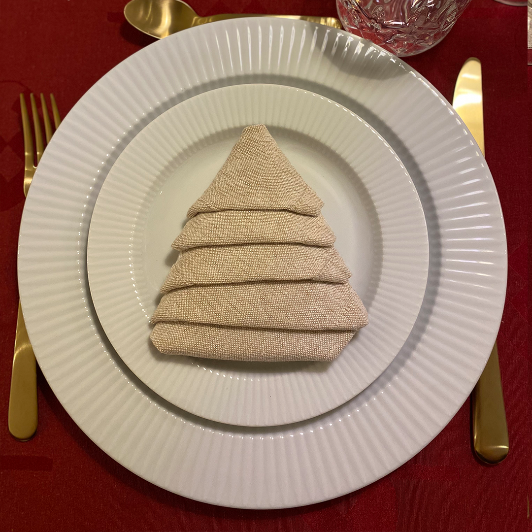 Napkin folded into the shape of a Christmas tree